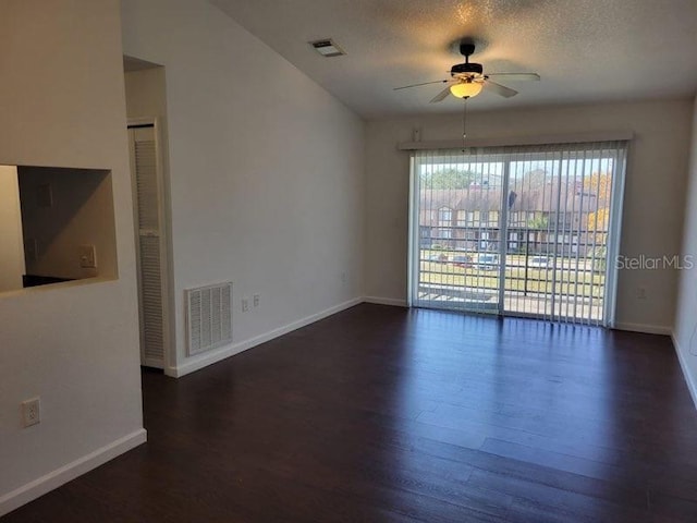 empty room with a ceiling fan, visible vents, and wood finished floors