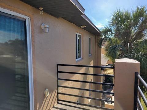 view of home's exterior featuring a balcony and stucco siding