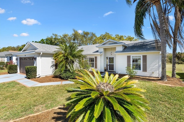 single story home with a front lawn, driveway, and an attached garage