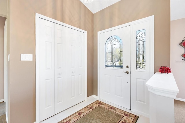 entryway featuring baseboards and light tile patterned flooring