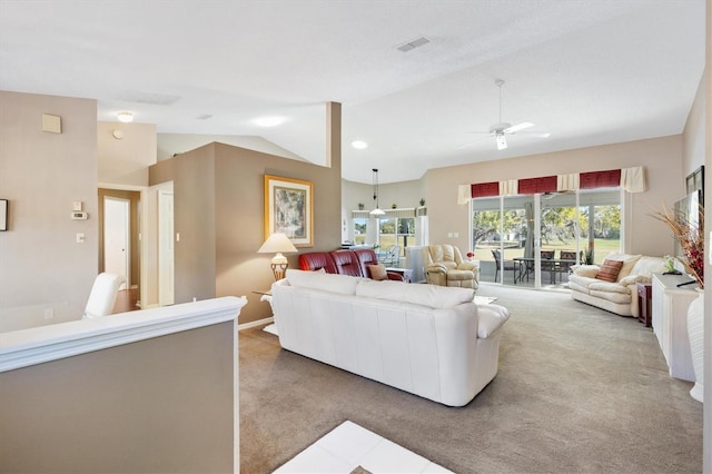 living area with plenty of natural light, carpet flooring, and vaulted ceiling