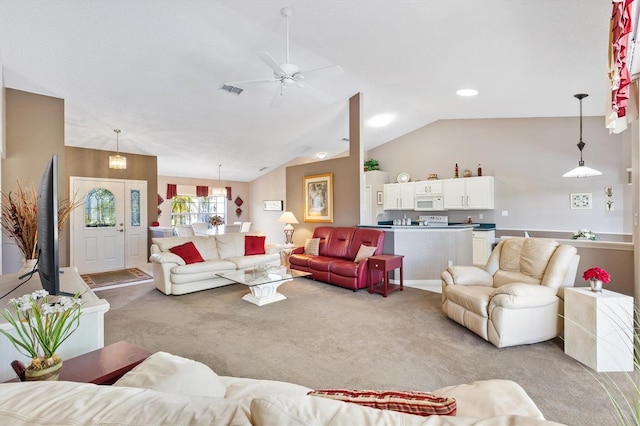 living room with visible vents, vaulted ceiling, a ceiling fan, and light colored carpet