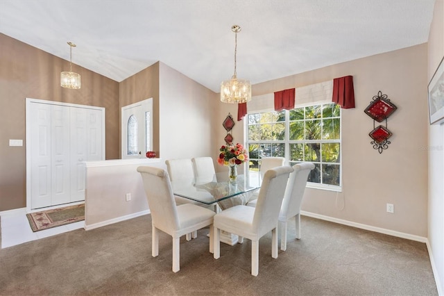 dining space featuring a chandelier, carpet, lofted ceiling, and baseboards