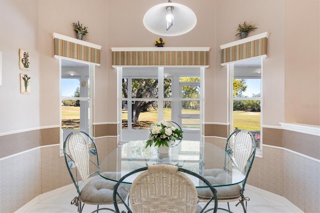 dining space featuring a high ceiling and carpet