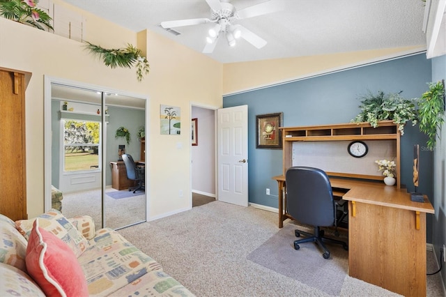 home office with carpet floors, lofted ceiling, baseboards, and a ceiling fan