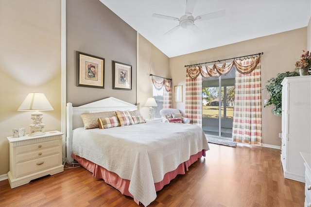 bedroom with wood finished floors, a ceiling fan, baseboards, vaulted ceiling, and access to outside