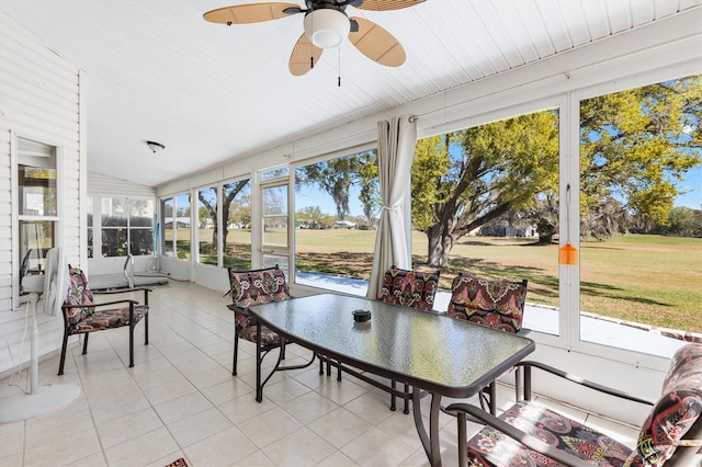 sunroom / solarium with vaulted ceiling, ceiling fan, and a wealth of natural light