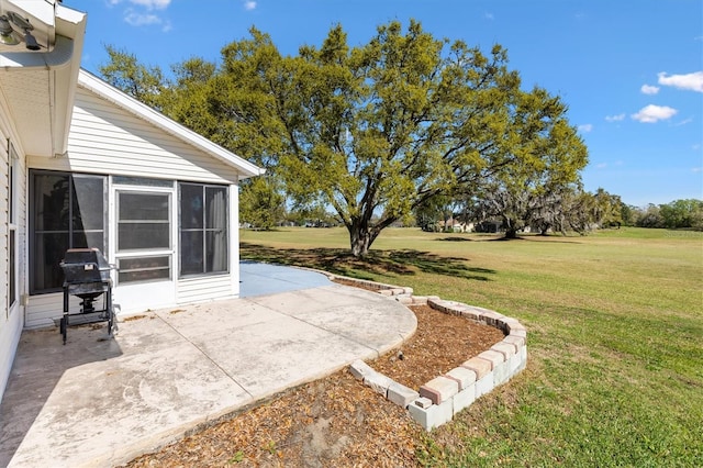 view of yard featuring a patio and a sunroom