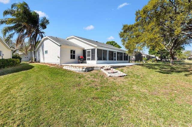 back of house with a sunroom, a patio area, and a yard