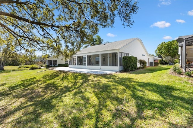 back of house with a yard and a sunroom