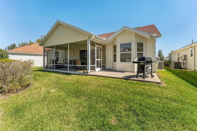 back of house featuring central AC unit, a lawn, a patio area, and a sunroom