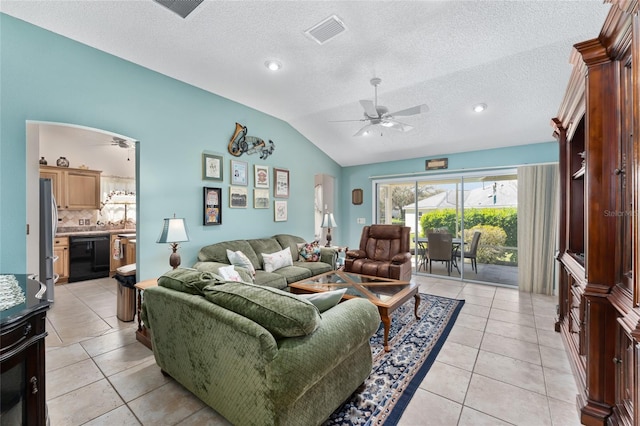 living area featuring light tile patterned floors, arched walkways, visible vents, a ceiling fan, and vaulted ceiling