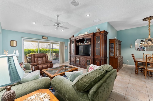 living room featuring visible vents, light tile patterned flooring, vaulted ceiling, a textured ceiling, and ceiling fan with notable chandelier