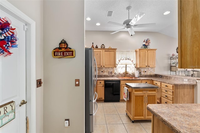 kitchen featuring light tile patterned floors, decorative backsplash, freestanding refrigerator, a sink, and dishwasher