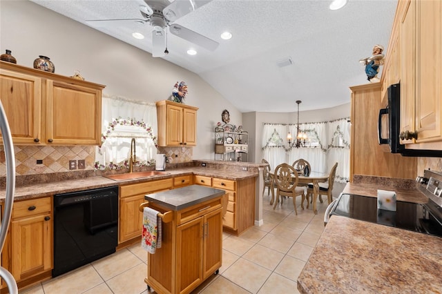 kitchen featuring black appliances, a peninsula, a sink, and light tile patterned flooring