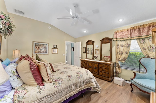 bedroom with lofted ceiling, light wood-style floors, visible vents, and a ceiling fan