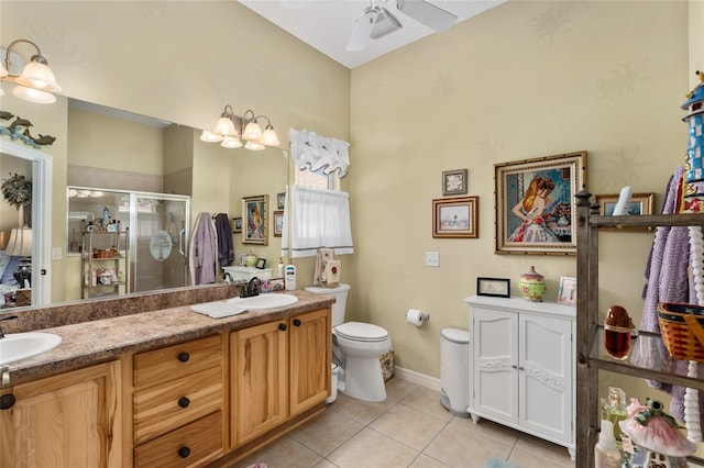 full bathroom featuring a shower stall, double vanity, a sink, and tile patterned floors