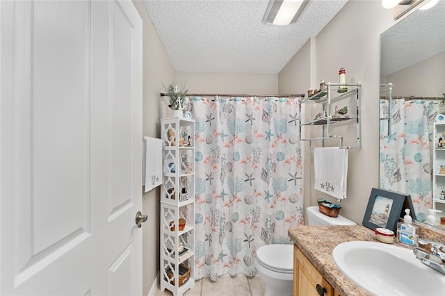 bathroom with toilet, tile patterned floors, curtained shower, a textured ceiling, and vanity