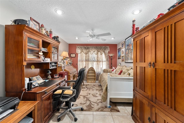 office space featuring light tile patterned flooring, ceiling fan, and a textured ceiling