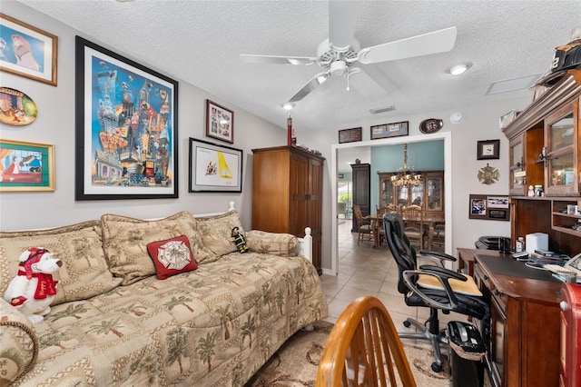 bedroom featuring light tile patterned floors, ceiling fan, and a textured ceiling