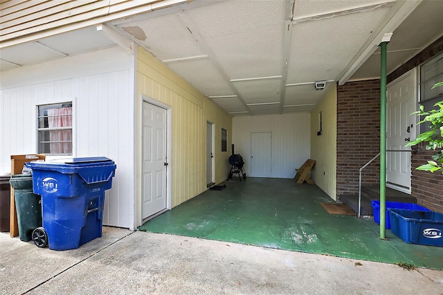 interior space with a carport and visible vents