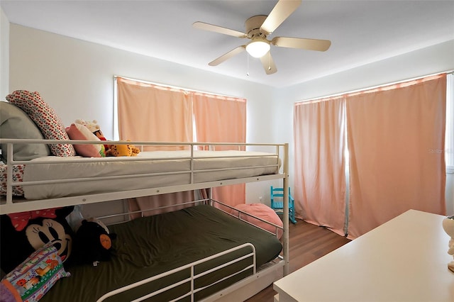 bedroom with a ceiling fan and wood finished floors