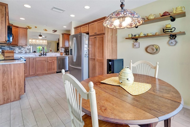 dining room with recessed lighting, visible vents, and light wood-type flooring