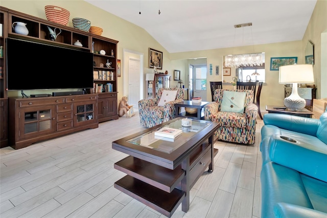 living area featuring a notable chandelier, visible vents, lofted ceiling, and wood tiled floor