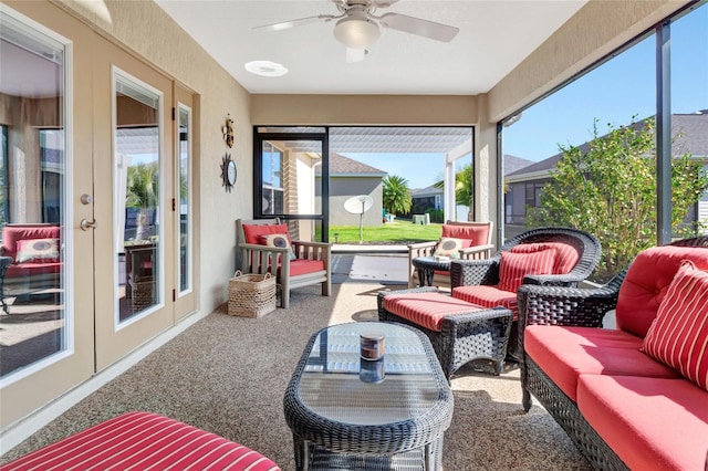 sunroom with a ceiling fan and french doors