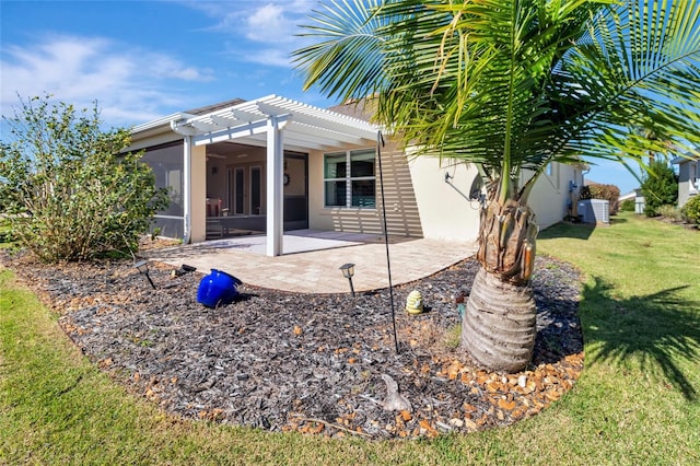 exterior space featuring stucco siding, a pergola, a yard, cooling unit, and a patio area