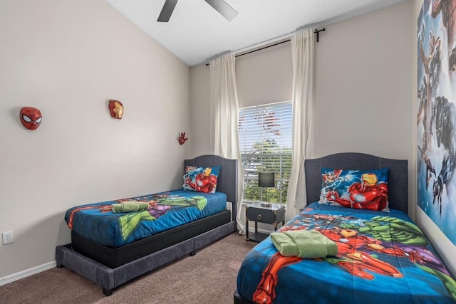 carpeted bedroom with ceiling fan, baseboards, vaulted ceiling, and a textured ceiling