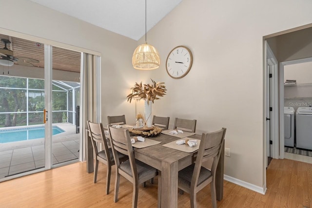 dining area featuring ceiling fan, a sunroom, baseboards, washer and dryer, and light wood-type flooring