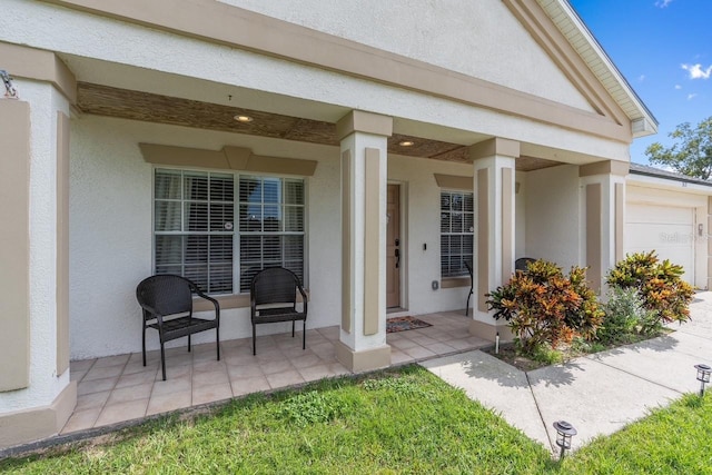 doorway to property featuring covered porch and stucco siding