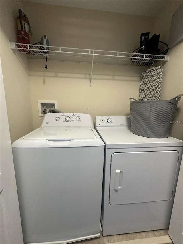 clothes washing area with laundry area and independent washer and dryer