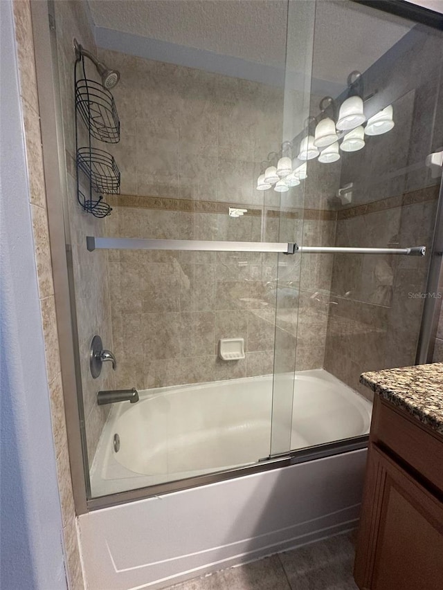 bathroom featuring combined bath / shower with glass door, vanity, and tile patterned floors