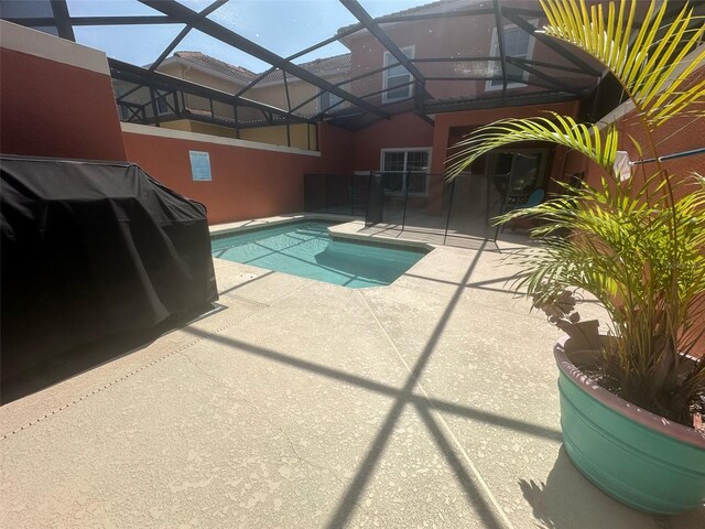 pool featuring a lanai and a patio area