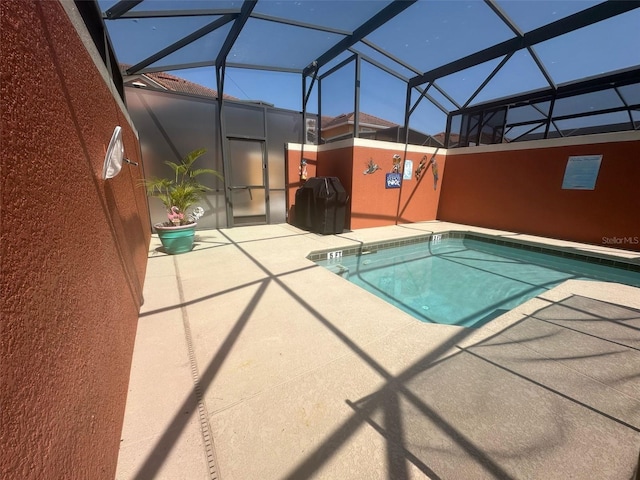 view of pool featuring a pool, a lanai, and a patio