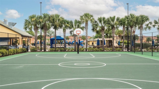 view of basketball court featuring community basketball court and fence