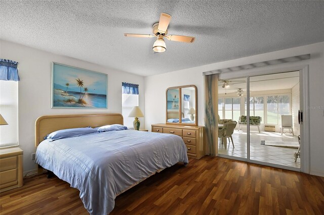 bedroom with access to exterior, a ceiling fan, a textured ceiling, and dark wood-style floors