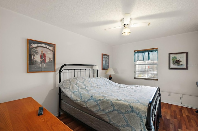 bedroom featuring baseboards, a textured ceiling, a ceiling fan, and wood finished floors