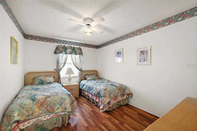 bedroom with a textured ceiling, ceiling fan, wood finished floors, and baseboards