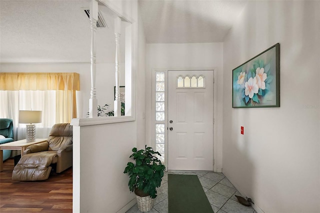 tiled entrance foyer featuring visible vents