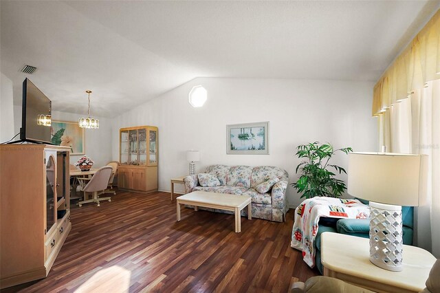 living room featuring dark wood-type flooring, lofted ceiling, visible vents, and an inviting chandelier