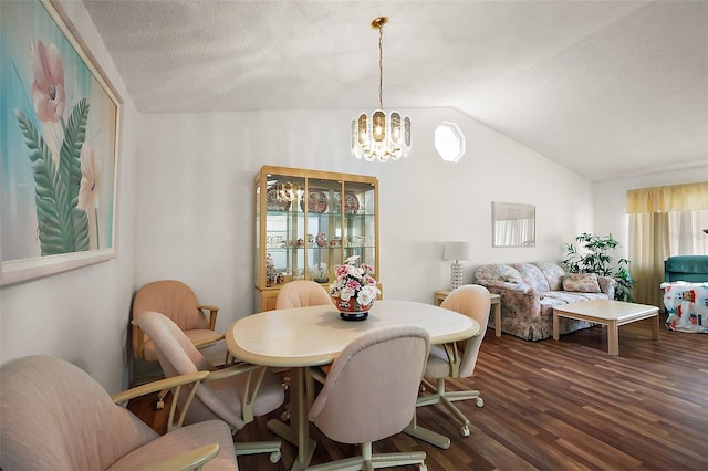 dining room featuring vaulted ceiling, a textured ceiling, dark wood-style floors, and a notable chandelier