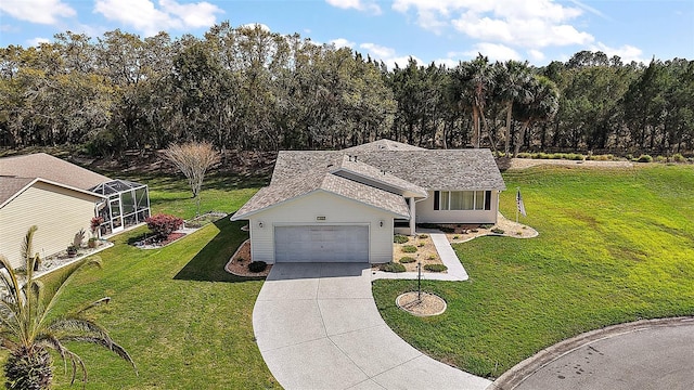 view of front facade with a garage, concrete driveway, a shingled roof, and a front yard