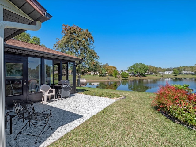 view of yard with a patio and a water view