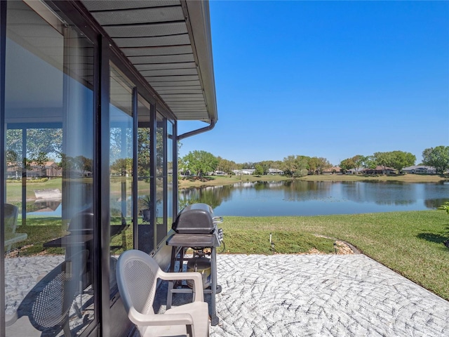 view of patio featuring grilling area and a water view