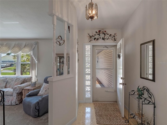 entrance foyer featuring baseboards and a notable chandelier