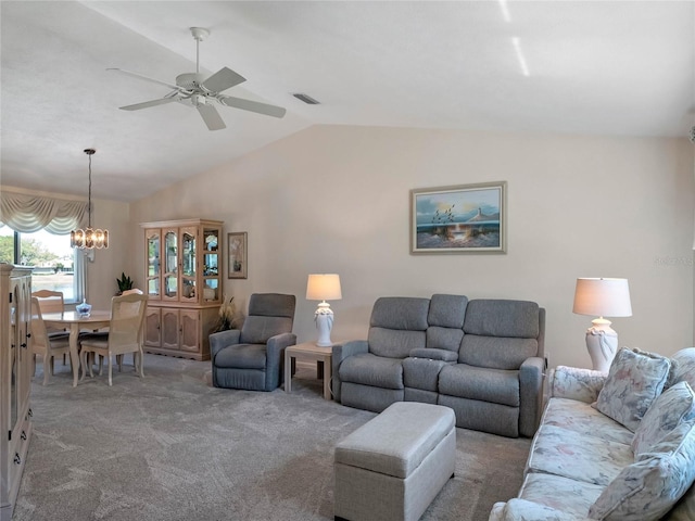 carpeted living room featuring visible vents, lofted ceiling, and ceiling fan with notable chandelier