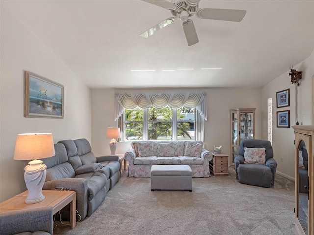 carpeted living room with a ceiling fan